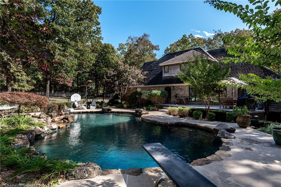 In ground gunite pool has waterfall, spa and dive board