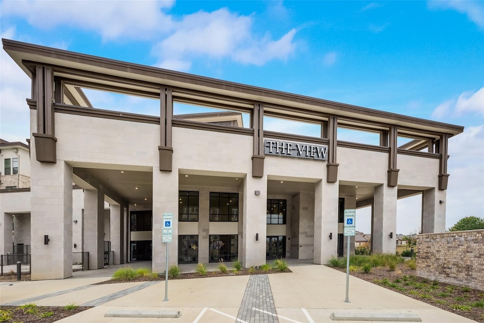 View of building exterior with uncovered parking