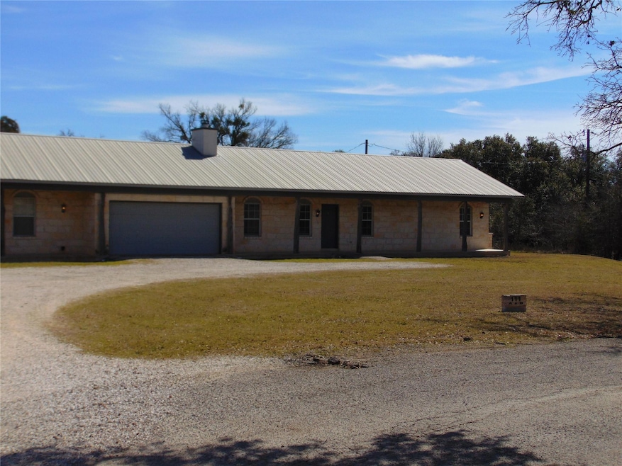 Ranch-style house featuring a garage, a front yar