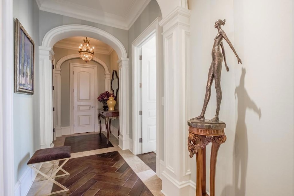 Foyer entrance with a chandelier, dark parquet flo