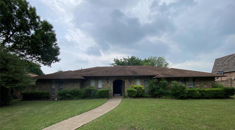 Single story home featuring a front lawn