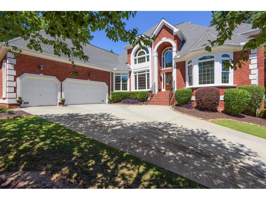 Beautiful colonial home with well manicured lawn.