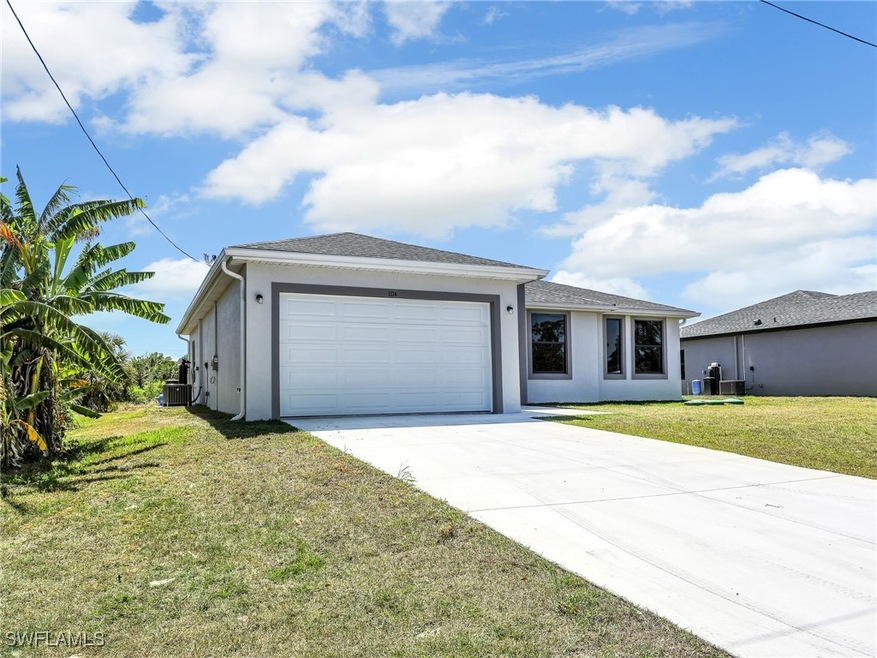 View of front of home with a front yard, concrete