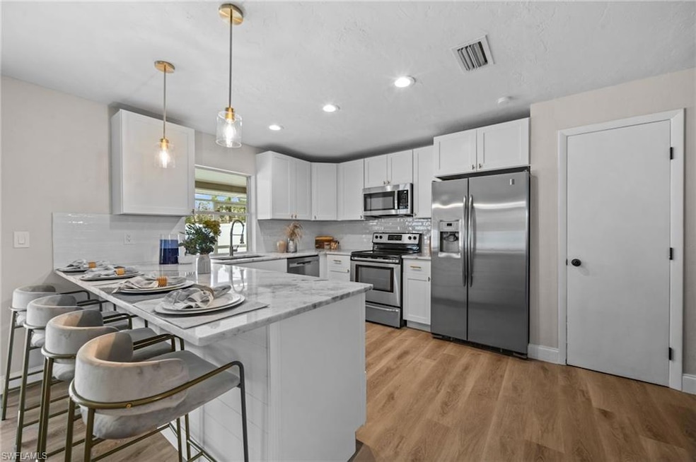 Kitchen featuring a breakfast bar, stainless steel