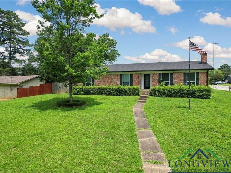 Single story home featuring brick siding and a chimney