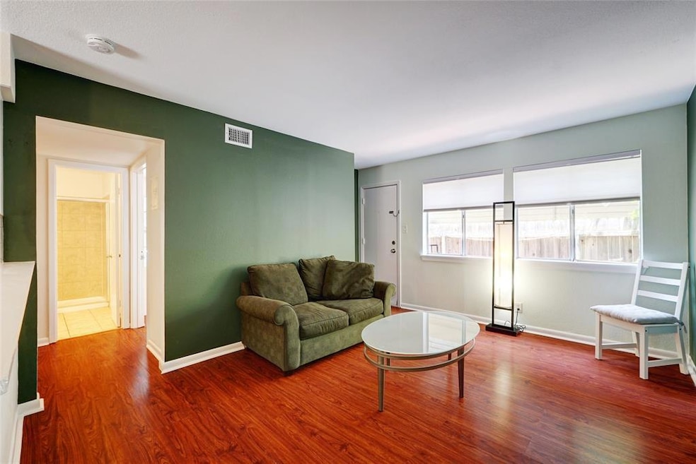 Living area featuring wood finished floors and ba
