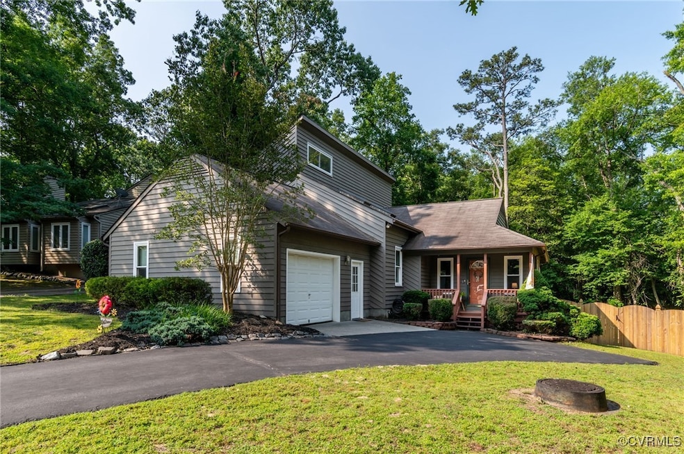 View of front of house featuring a porch, asphalt