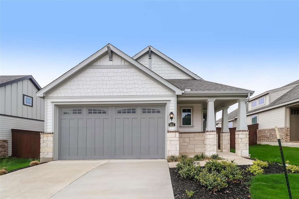 Craftsman-style home with stone siding, concrete 