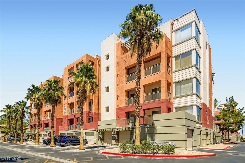 View of Condos complex featuring uncovered parking