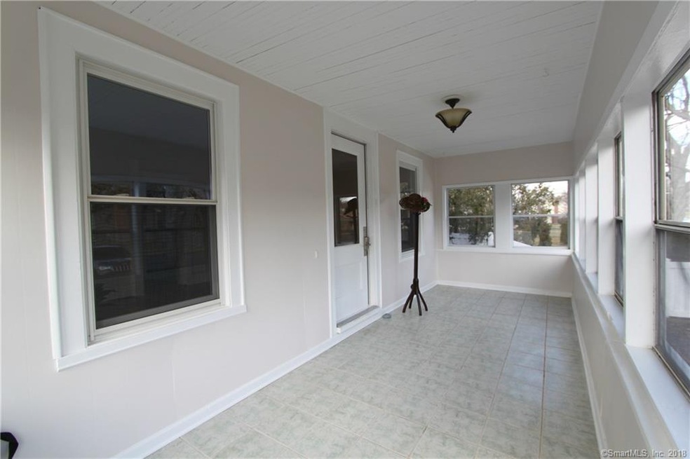Large, covered porch with tile flooring is just ic