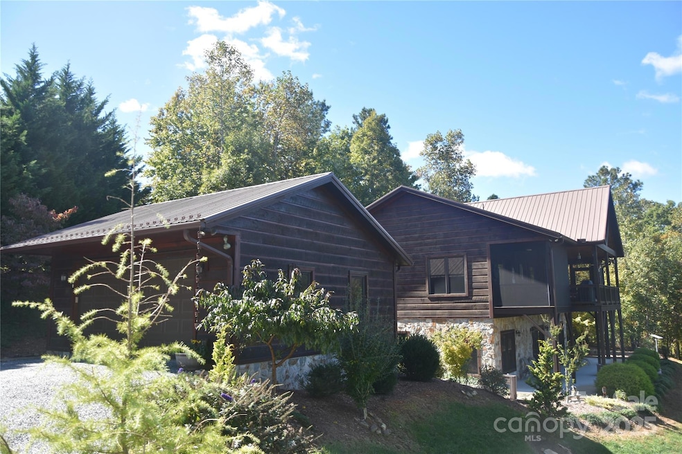 View of the detached garage and home from the driveway.