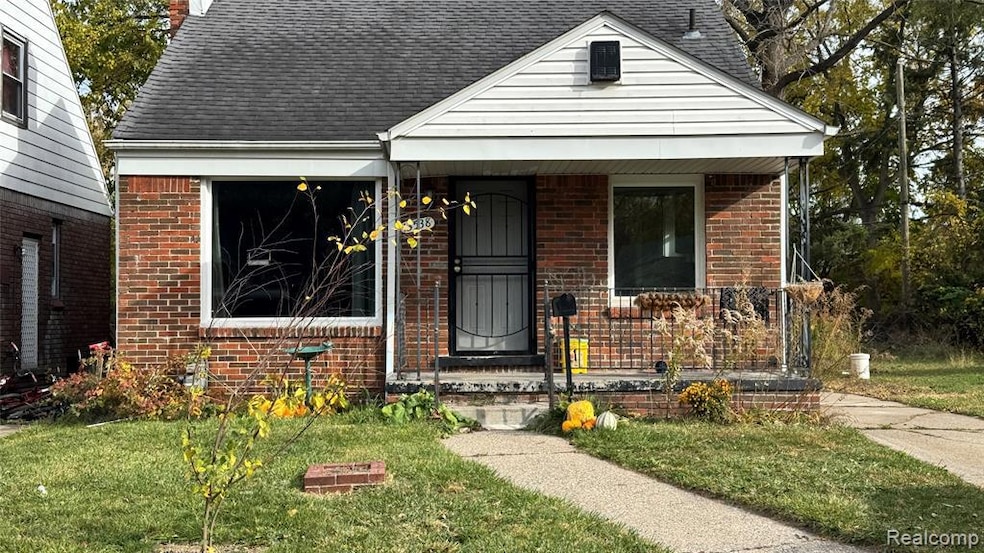 View of front of home with a porch, a front yard, brick siding, roof with shingles, and a chimney