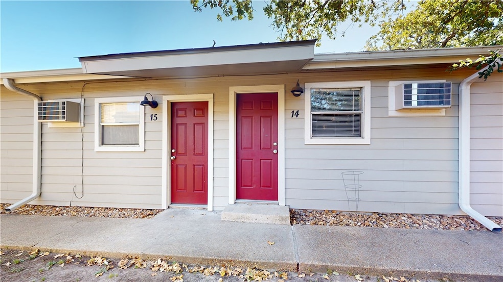 Doorway to property featuring covered porch