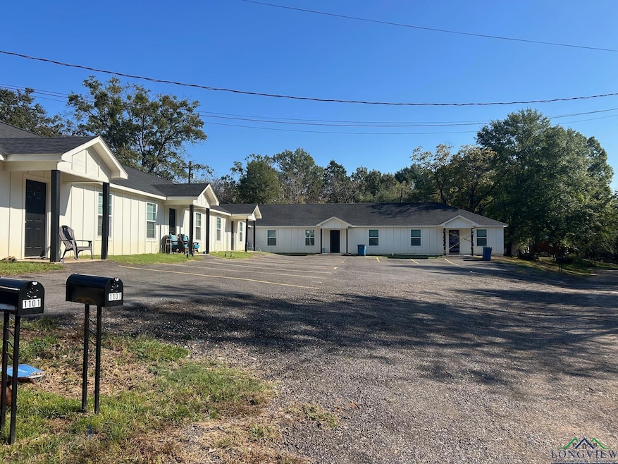 View of front facade featuring board and batten siding, roof with shingles, and covered porch