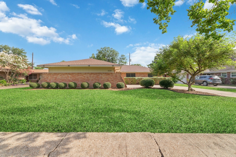 This charming single-story brick home in Robindell