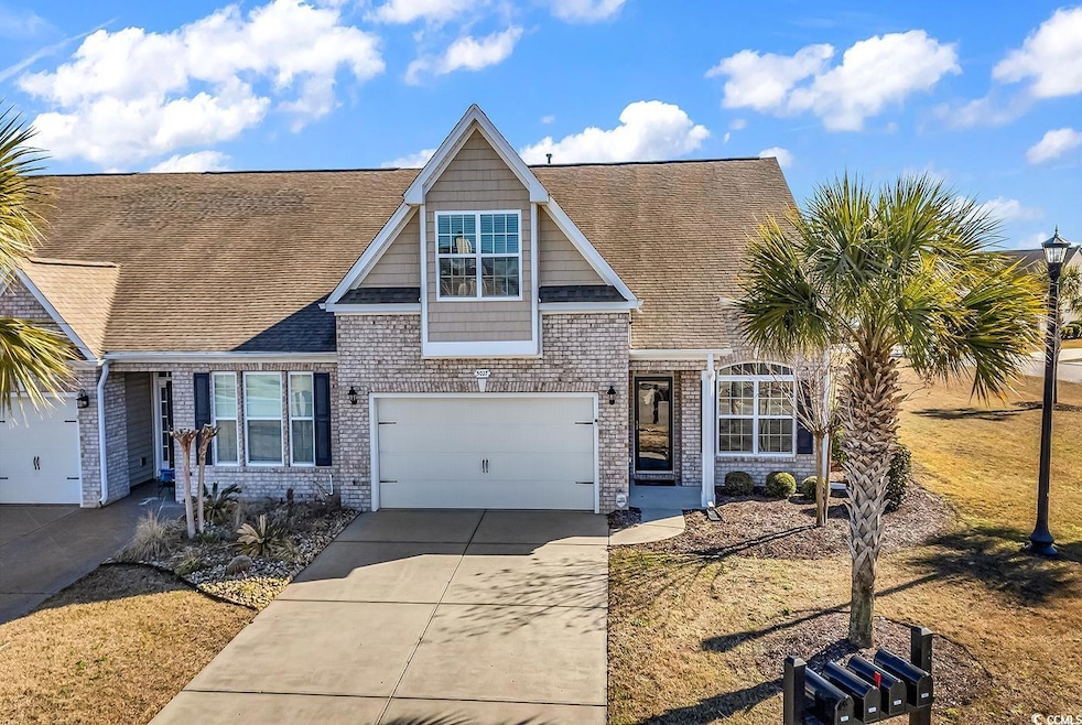View of front of home with concrete driveway, roof