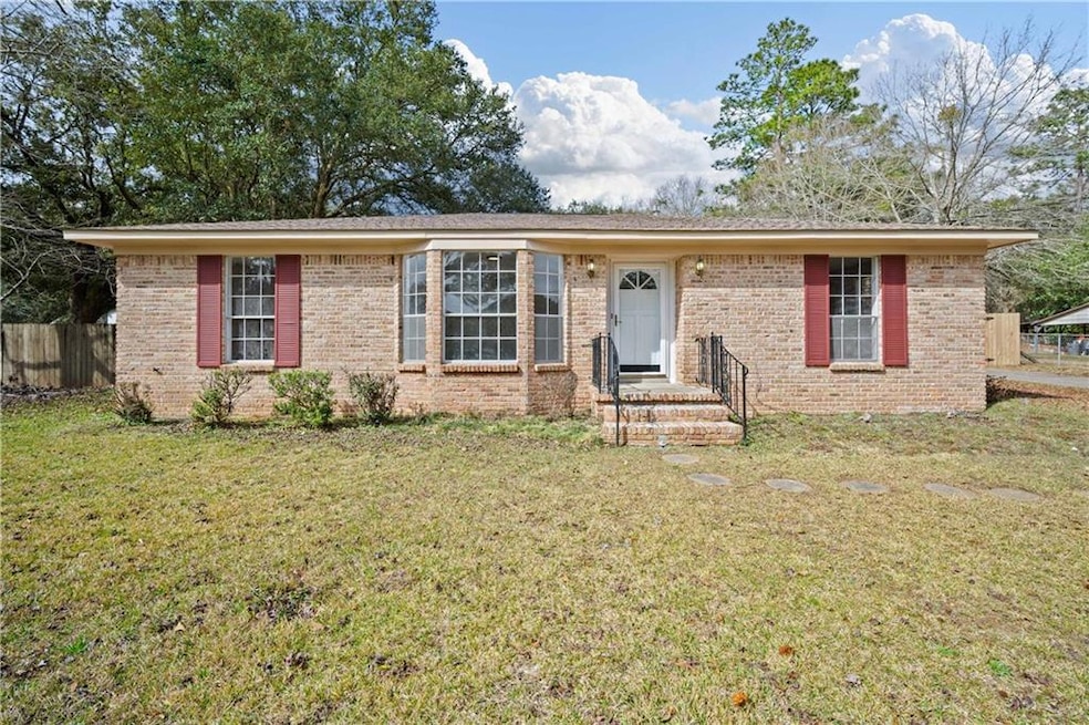 Single story home featuring brick siding, a front 