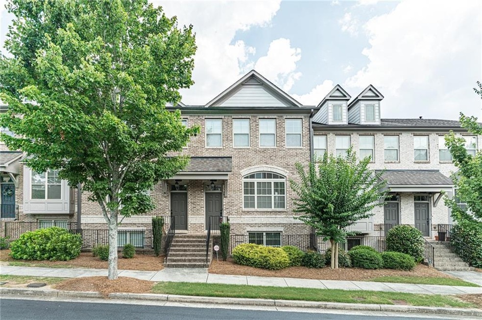 View of property featuring brick siding and a fenced front yard