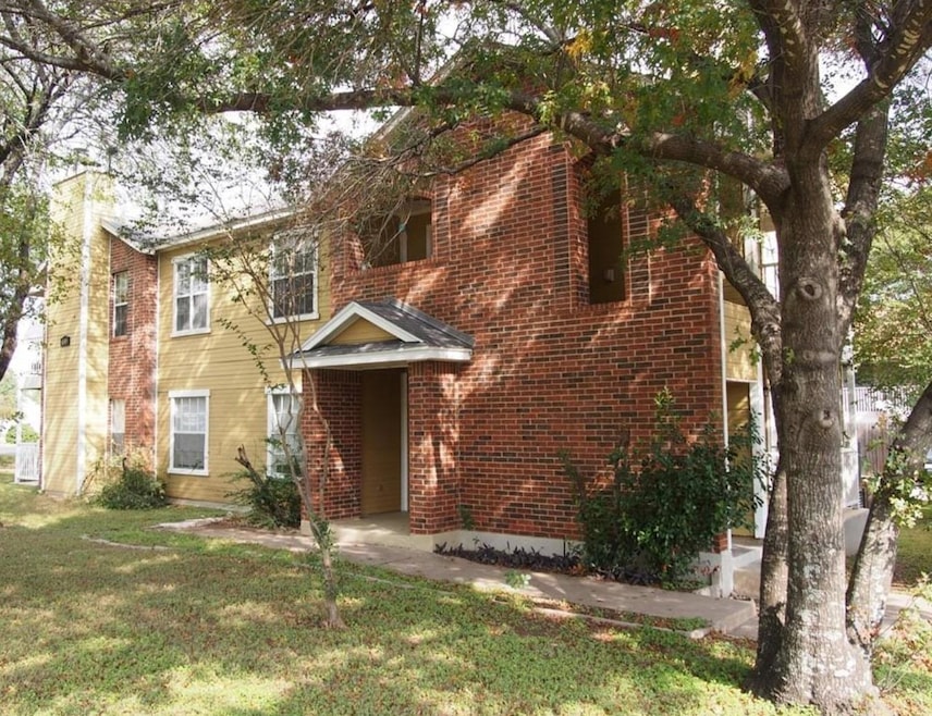 View of front facade featuring a front lawn, bric