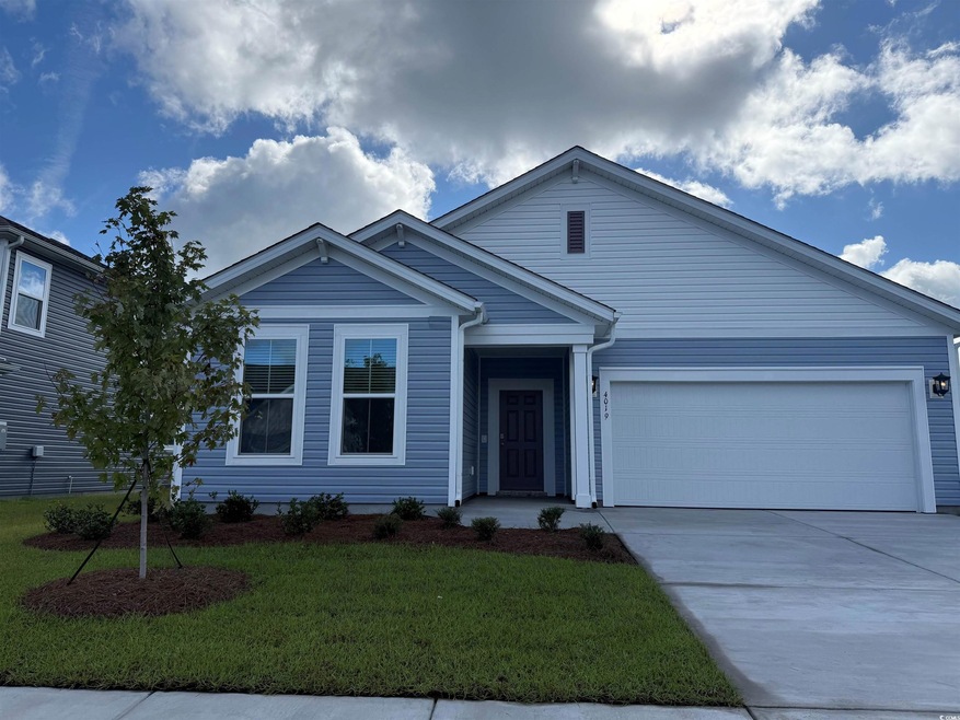 Ranch-style house with a front yard, an attached garage, and concrete driveway