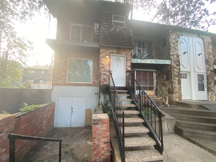 Property entrance featuring brick siding