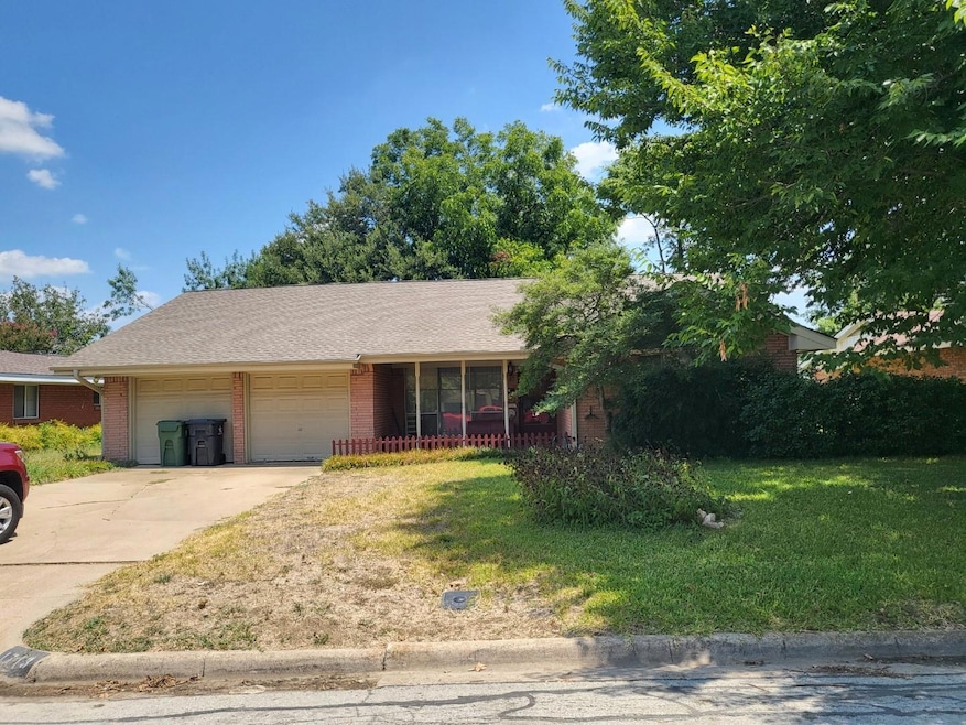 View of front of home with a garage and a front la