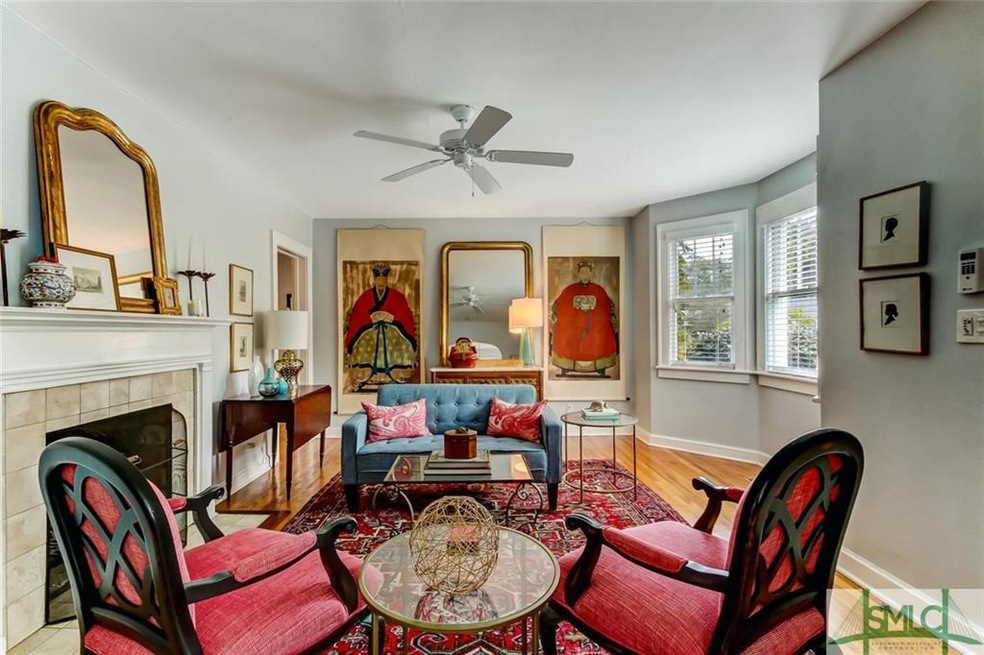 Spacious living room with bayed window, lovely fireplace, and plenty of space for entertaining.