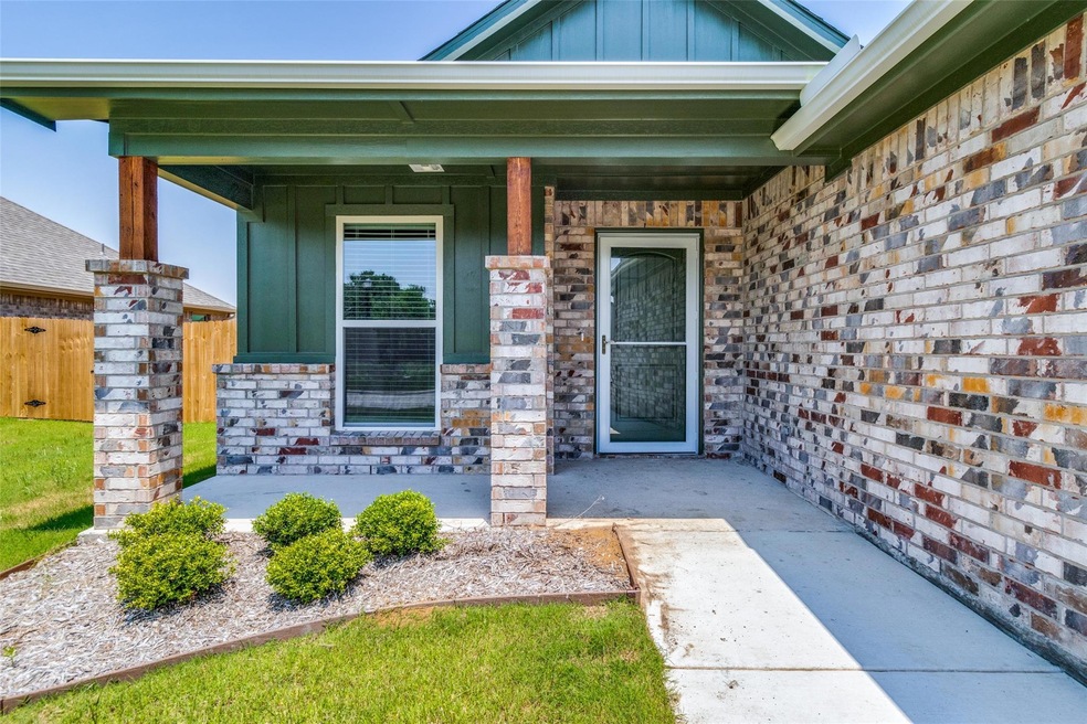 Doorway to property with covered porch, large enough for rocking chairs or bench