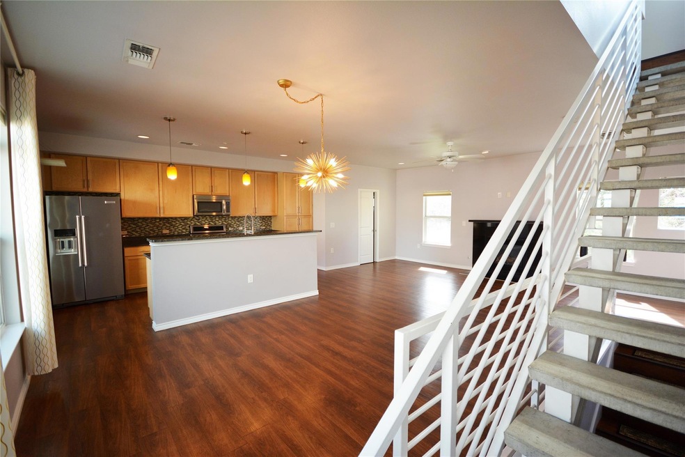 Kitchen with dark wood-style flooring, visible ve
