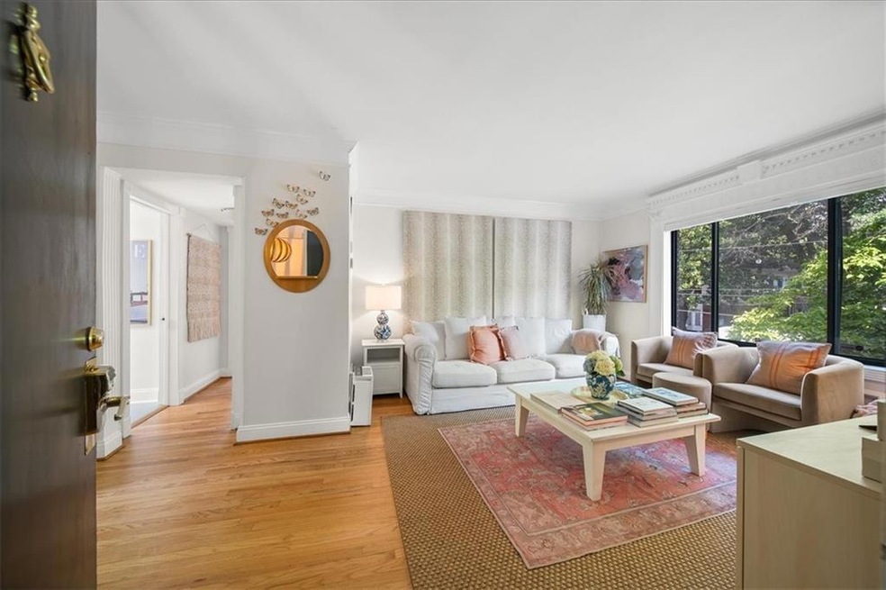 Living room featuring wood flooring and ornamental molding
