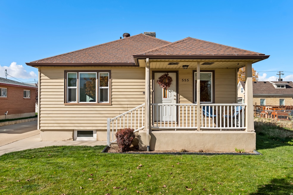 Bungalow featuring a front lawn, covered porch, and a shingled roof