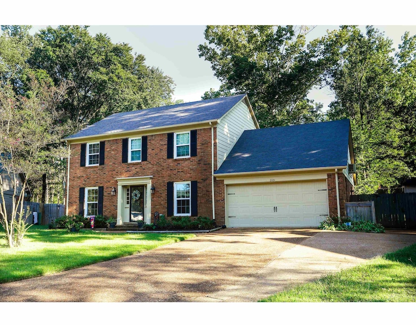 Colonial-style house featuring a front yard and a 