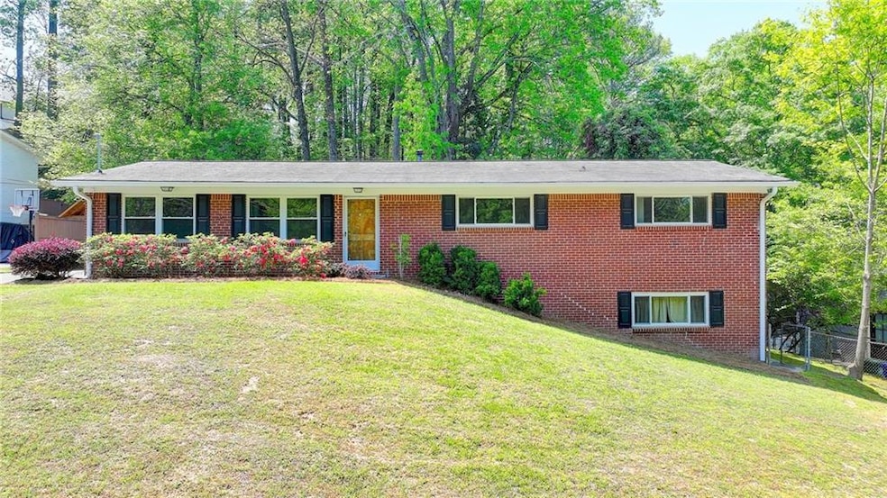 Single story home featuring brick siding, a front 
