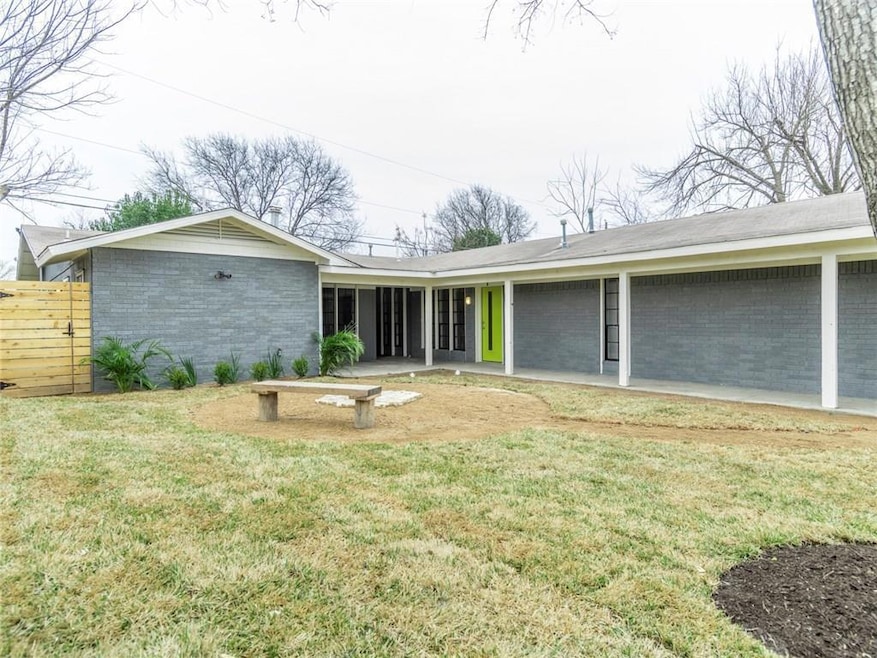 View of front facade featuring brick siding and a patio area