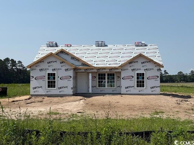 View of front of home with roof with shingles