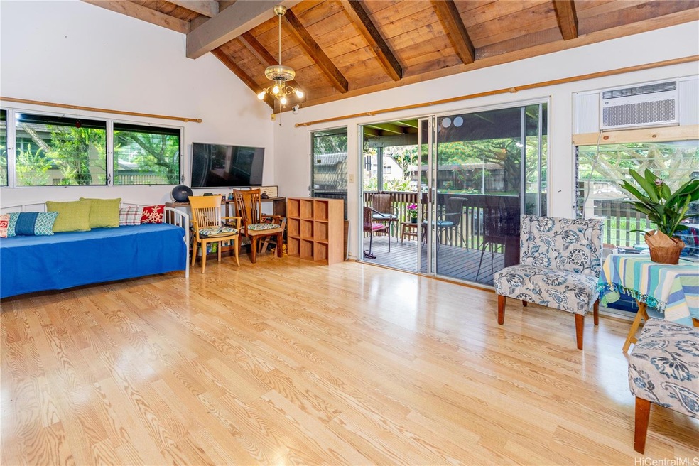 Spacious living room with roofed lanai. Vaulted ce