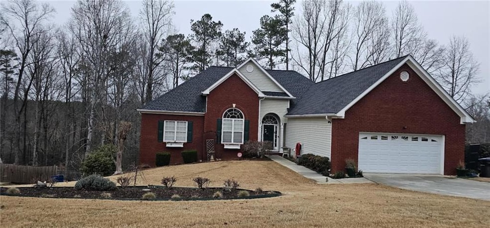 Traditional home featuring a front yard, concrete 
