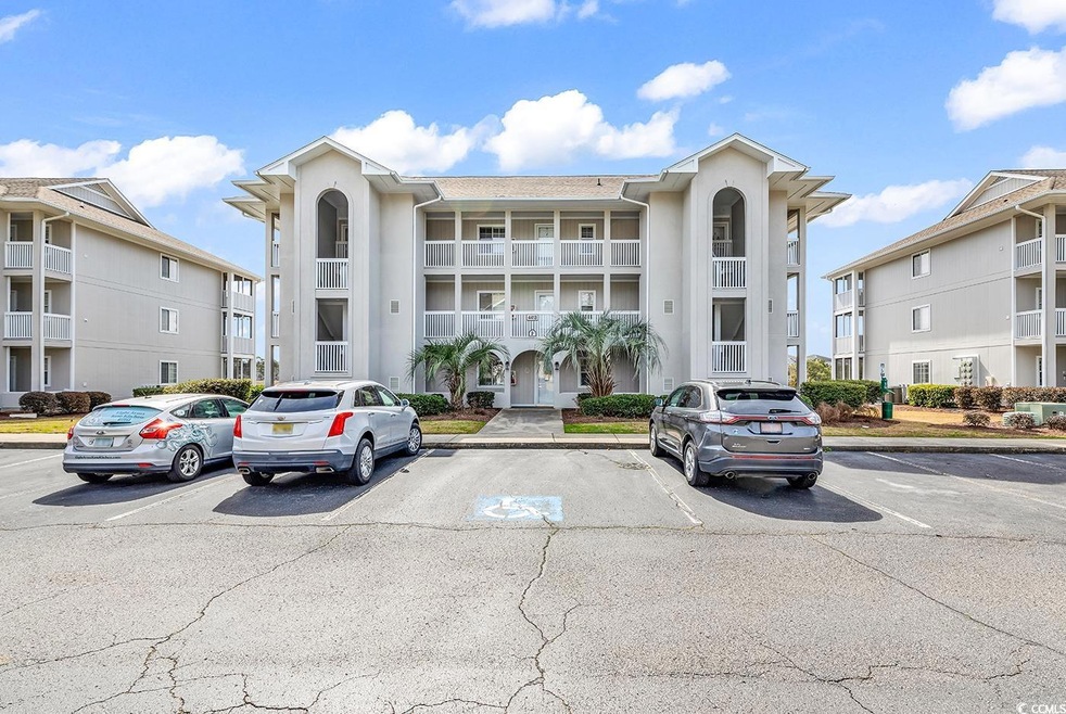 View of property featuring uncovered parking