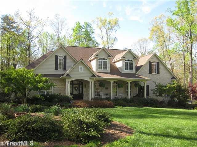 Exterior Front.  Private cul de sac lot. Custom design with interesting porches, gables and roof lines.  An abundance of windows and French doors bring the outdoors to the inside.  There is nothing boring about this beautiful home.  Low maintenance brick and vinyl exterior, vinyl windows.