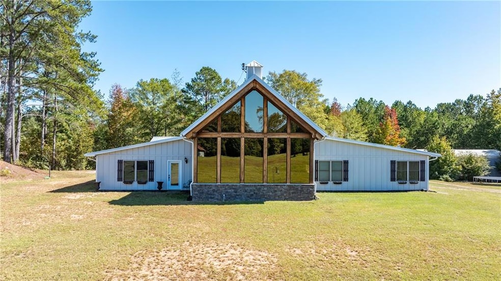 Rear view of property with a lawn