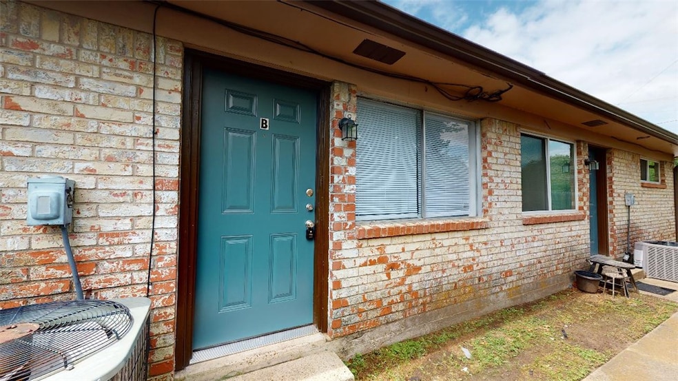 Doorway to property featuring brick siding
