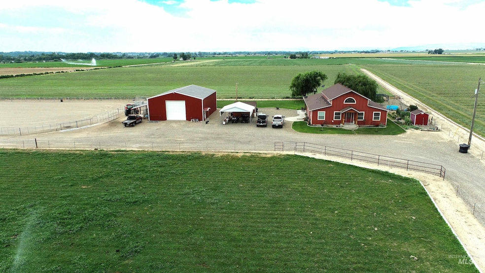 View of yard featuring a view of rural / pastoral area, an outbuilding, and a shop