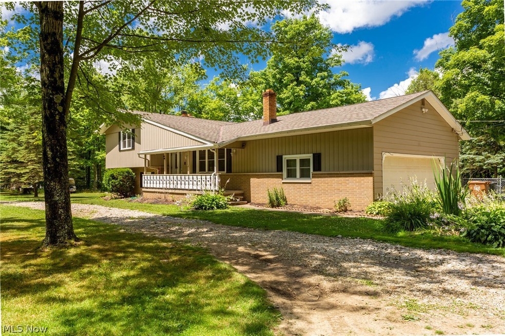 Front view of the split level home on 5.75 acres of wooded property.