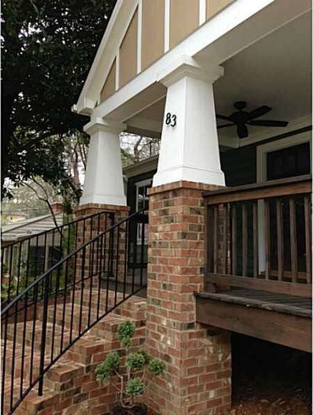 Exterior Front. Winding brick stair with iron rail