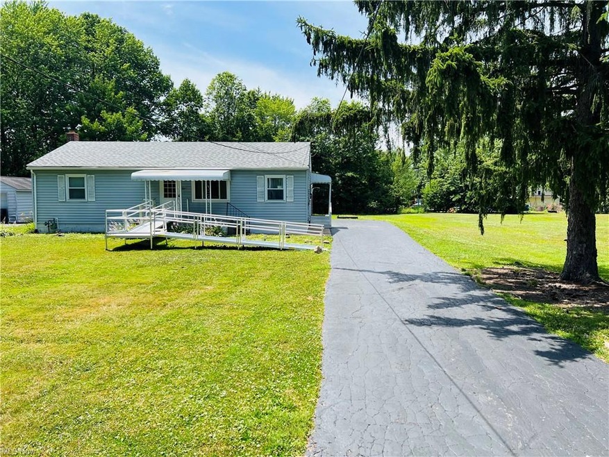Two car garage in rear, sits on two lots.