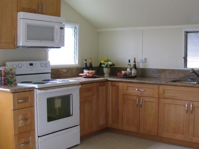 Granite counter tops with wood cabinets.