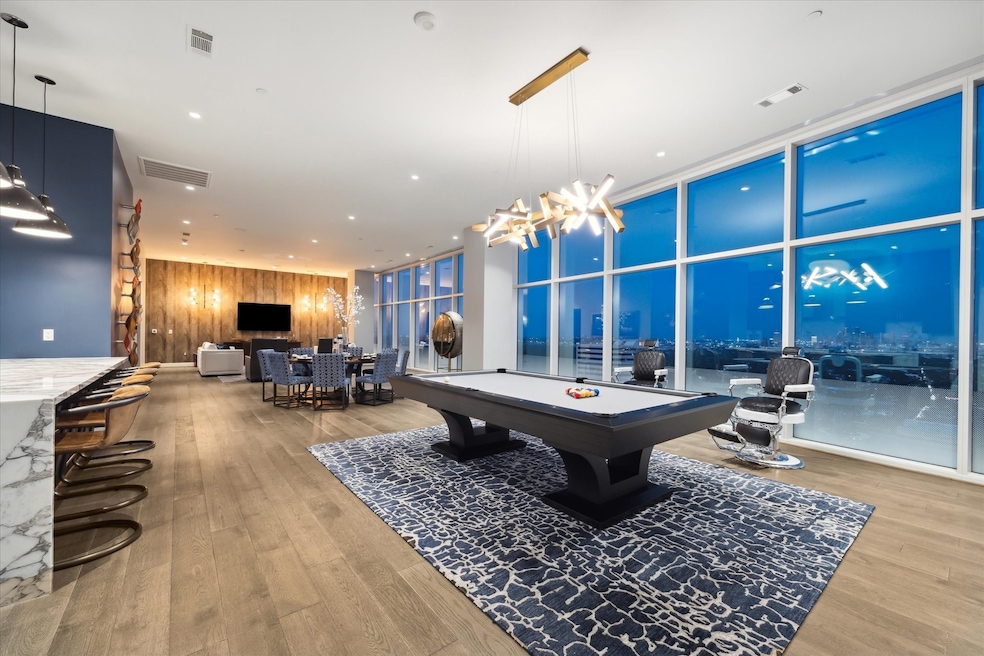 Floor-to-ceiling windows frame the cityscape, maki