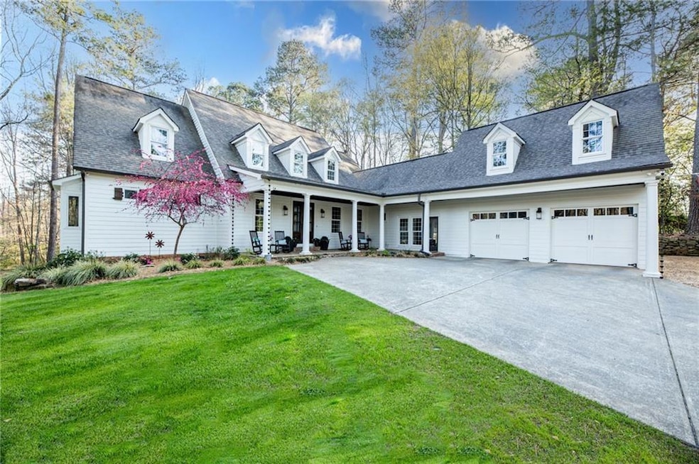Crapapple Cottage home with driveway, a front yard, covered porch, and an attached garage