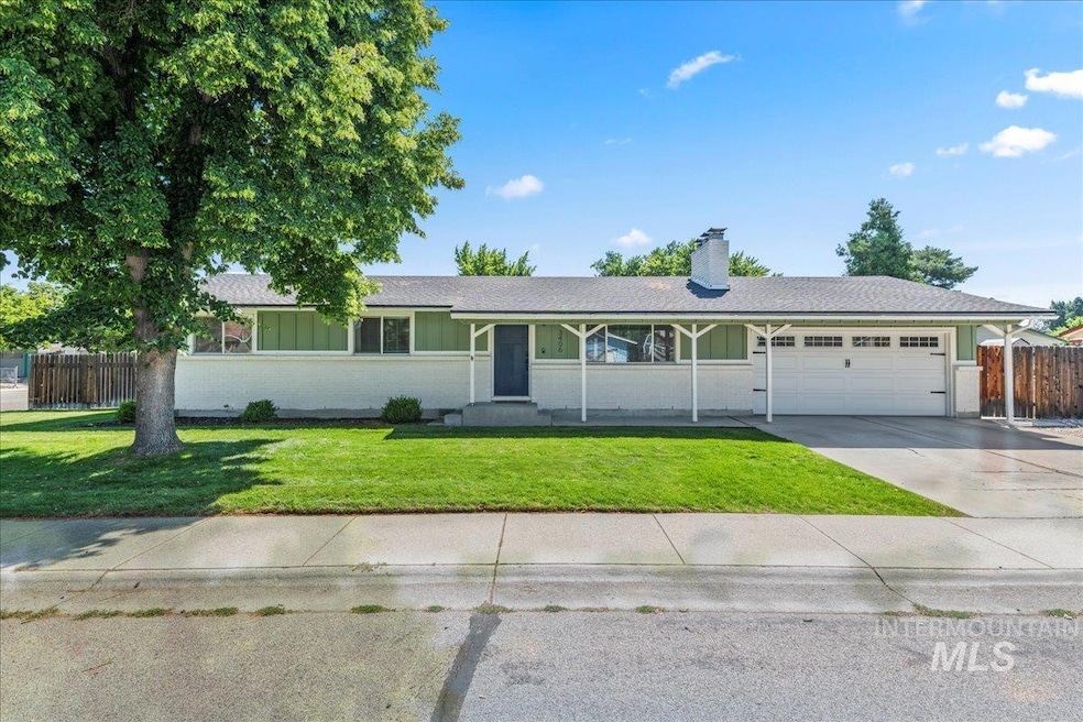 Ranch-style home with an attached garage, a chimney, and concrete driveway
