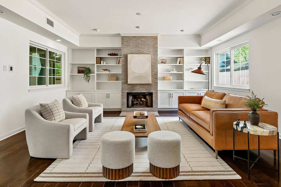Living area featuring crown molding, visible vent